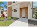Stylish entryway with a modern door and landscaped walkway at 3112 Rockefeller Way, Kissimmee, FL 34747