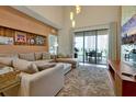 Spacious living area featuring a sectional sofa and access to a patio at 3112 Rockefeller Way, Kissimmee, FL 34747