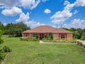 Charming single-story home with a landscaped yard and beautiful curb appeal at 16300 Johns Lake Rd, Clermont, FL 34711