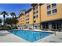 Inviting hotel pool surrounded by lounge chairs and offering a relaxing atmosphere at 3000 Maingate Ln # 317, Kissimmee, FL 34747