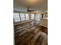 Living room with dark wood-look floors and a ceiling fan at 1027 S Hiawassee Rd # 2313, Orlando, FL 32835