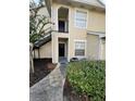 Building exterior with a black metal staircase and landscaping at 1027 S Hiawassee Rd # 2313, Orlando, FL 32835