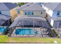 Aerial view of a home with a screened-in pool and spa at 9025 Sunshine Ridge Loop, Kissimmee, FL 34747