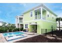Private pool and spa with patio furniture and lush landscaping at 8035 Knee Deep Rd, Kissimmee, FL 34747