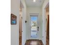 Bright and airy entryway with tiled floors and access to bedrooms at 8035 Knee Deep Rd, Kissimmee, FL 34747