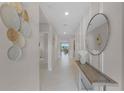 Bright and airy entryway with a console table and mirror at 679 Lazio Cir, Debary, FL 32713