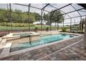 Screened pool and spa with stone decking at 5769 Saybrook Cir, Sanford, FL 32771