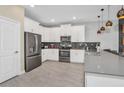 Modern kitchen with white cabinets, gray countertops, and stainless steel appliances at 4509 Target Blvd, Kissimmee, FL 34746