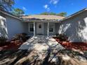 Newly painted house exterior with walkway and landscaping at 32205 State Road 44, Eustis, FL 32736