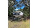 Single-story house with light blue exterior, landscaping at 32205 State Road 44, Eustis, FL 32736