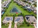 Aerial view of house with pond and solar panels at 15465 Heron Hideaway Cir, Winter Garden, FL 34787