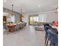 Spacious dining room with modern chandelier, large table, and access to a balcony at 2126 Lelani Cir, Davenport, FL 33897
