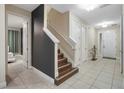 Bright and spacious entryway with tile flooring and staircase leading to the second floor at 2689 Calistoga Ave, Kissimmee, FL 34741