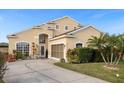 Two-story house with a beige exterior, landscaped yard, and a two-car garage at 2570 Amaya Ter, Lake Mary, FL 32746