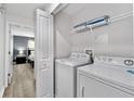 Modern laundry room with washer, dryer, and shelving at 4803 Brier Rose Ln, Kissimmee, FL 34746