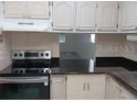 Kitchen with granite countertops and stainless steel appliances at 2860 N Powers Dr # 14, Orlando, FL 32818