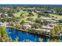 Community view with lush landscaping, water, and golf course at 6254 Masters Blvd # D106, Orlando, FL 32819