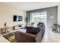 Bright living room featuring a sectional sofa and sliding doors at 619 Ocean Course Ave # 619, Davenport, FL 33896