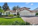 Mediterranean style home with a three-car garage and lush landscaping at 513 Worthington Dr, Winter Park, FL 32789