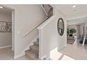 Bright and airy entryway with staircase leading upstairs at 2118 Charming Ave, Davenport, FL 33897