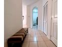 Clean hallway with tiled floors, linen closet, and bench at 2302 Silver Palm Dr # 301, Kissimmee, FL 34747