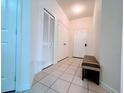 Bright hallway with tiled floors, a bench, and multiple doors at 2302 Silver Palm Dr # 301, Kissimmee, FL 34747