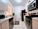 Modern kitchen with stainless steel appliances and ample cabinet space at 2302 Silver Palm Dr # 301, Kissimmee, FL 34747