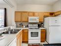 Well-equipped kitchen, featuring wood cabinets and modern appliances at 702 Calabria Ave, Davenport, FL 33897