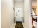Inviting entryway with tile flooring and shoe storage at 702 Calabria Ave, Davenport, FL 33897
