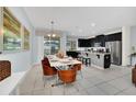 Bright dining area with modern table and chairs, adjacent to a kitchen at 1616 Carey Palm Cir, Kissimmee, FL 34747