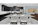 Modern kitchen with island, stainless steel appliances, and granite countertops at 1616 Carey Palm Cir, Kissimmee, FL 34747