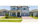 Two story home with gray siding and two car garage at 13978 Lanyard Way, Winter Garden, FL 34787