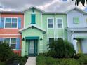 Brightly colored townhouse with palm trees at 2972 On The Rocks Pt, Kissimmee, FL 34747