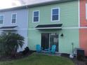 Small patio with teal chairs and table at 2972 On The Rocks Pt, Kissimmee, FL 34747