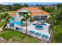 Large backyard oasis with pool, spa, and outdoor entertainment area at 7487 Gathering Dr, Reunion, FL 34747
