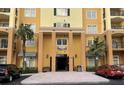 Building exterior featuring a main entrance and landscaping at 8100 Poinciana Blvd # 2203, Orlando, FL 32821