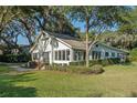 Stunning white house with a spacious lawn and mature trees at 635 Butler St, Windermere, FL 34786