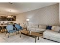 Open living room with L-shaped sofa and adjacent dining area at 545 Ocean Course Ave # 545, Davenport, FL 33896