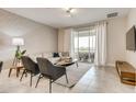 Bright living room with comfortable seating and sliding doors to balcony at 545 Ocean Course Ave # 545, Davenport, FL 33896