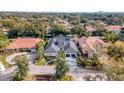 Aerial view of a luxury home with a large, covered pool at 9217 Hidden Bay Ln, Orlando, FL 32819