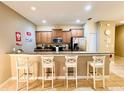 Well-equipped kitchen with granite countertops and wood cabinets at 8953 California Palm Rd, Kissimmee, FL 34747