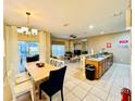 Open concept kitchen and dining area with light wood table at 8953 California Palm Rd, Kissimmee, FL 34747