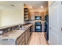 Modern kitchen with dark cabinets and granite counters at 28 W Esther St # A, Orlando, FL 32806
