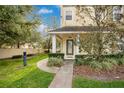Townhome entrance with landscaping and walkway at 28 W Esther St # A, Orlando, FL 32806