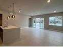 Open concept living area with tile floors and island kitchen at 7760 Sandy Ridge Dr # 119, Kissimmee, FL 34747