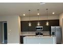 Modern kitchen with island and stainless steel appliances at 7760 Sandy Ridge Dr # 119, Kissimmee, FL 34747