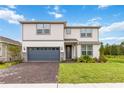 Two-story home with gray garage door and landscaping at 6030 Arbor Watch Loop, Orlando, FL 32829