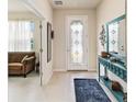Bright entryway with teal console table and mirror at 6030 Arbor Watch Loop, Orlando, FL 32829