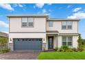 Two-story home with gray garage door and landscaping at 6030 Arbor Watch Loop, Orlando, FL 32829