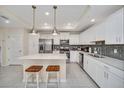 Modern kitchen with stainless steel appliances and an island with seating at 4741 Clock Tower Dr # 208, Kissimmee, FL 34746